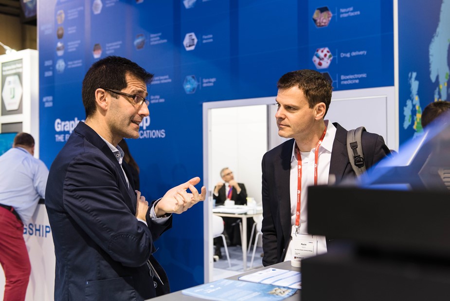 Researcher explaining a prototype at the Graphene Pavilion at Mobile World Congress 2018