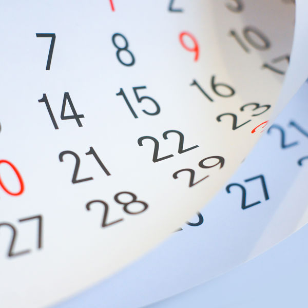 A wall calendar with pages flipping.