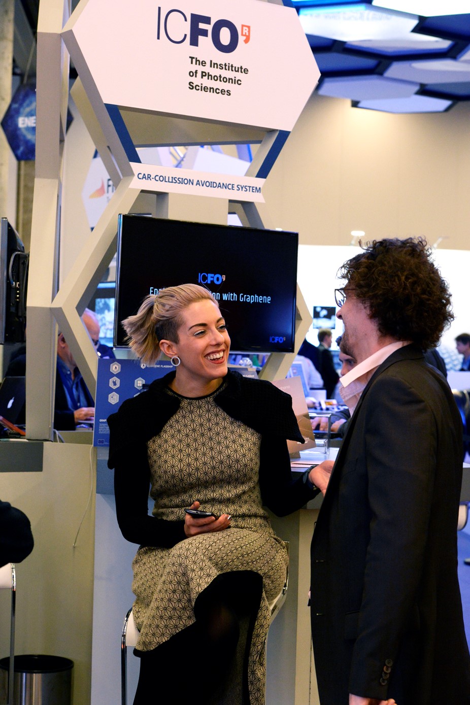 A reasercher explains her prototype at the Graphene Experience Zone at Mobile World Congress 2017