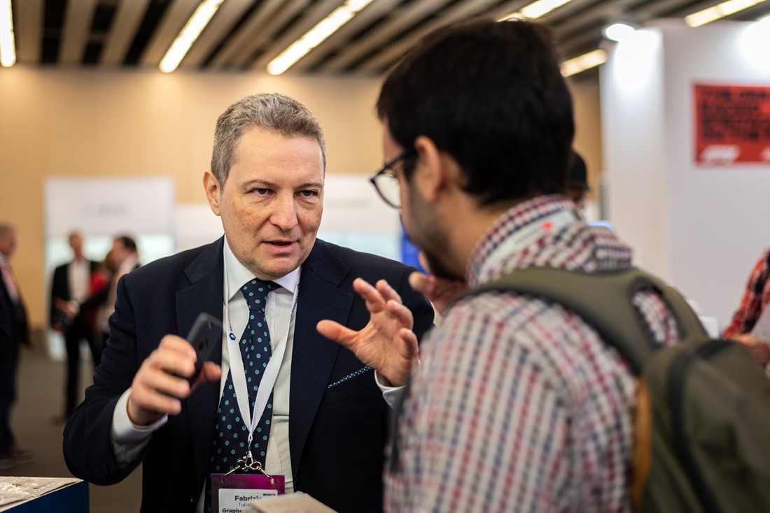 Fabrizio Tubertini, business developer for energy applications, speaks to a visitor to the Graphene Pavilion at Mobile World Congress. Image credit: Alexandra Csuport