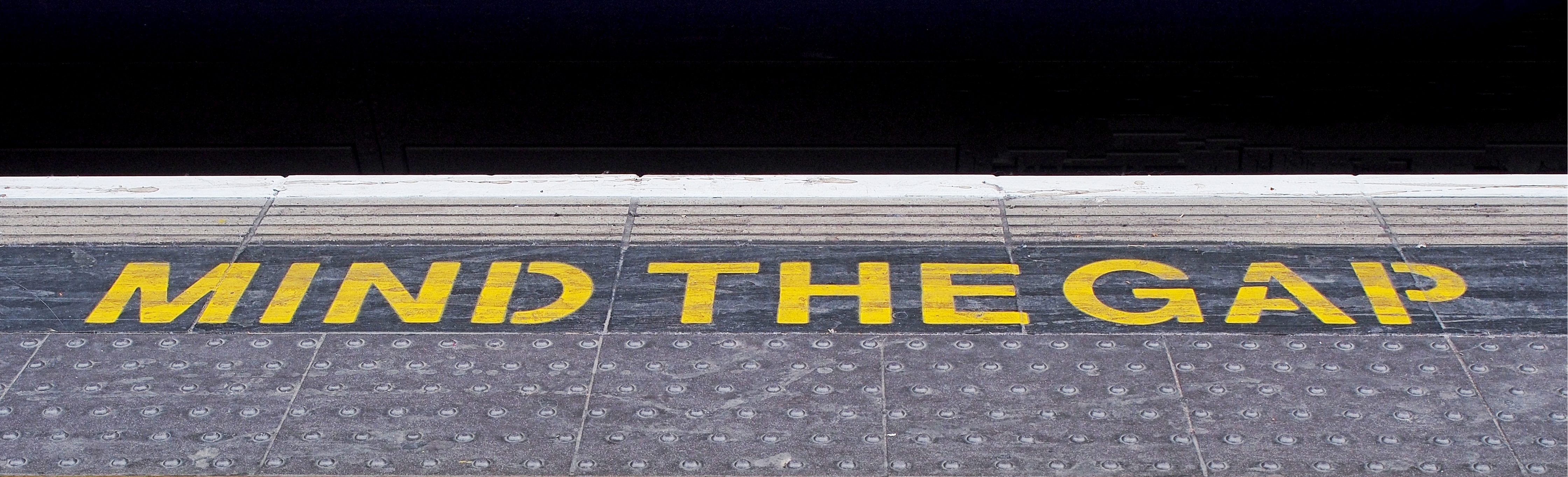 Mind the gap sign at underground train station.