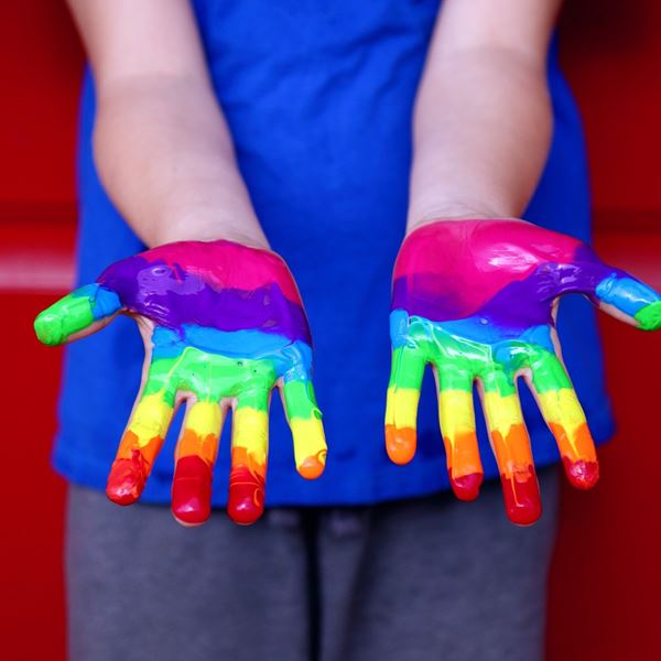 Hand with painted rainbow