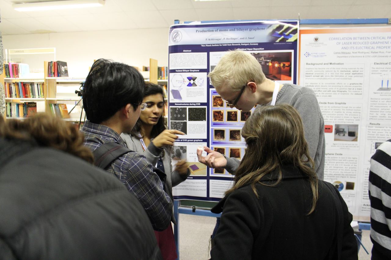 Students at Graphene Study discussing scientific posters.