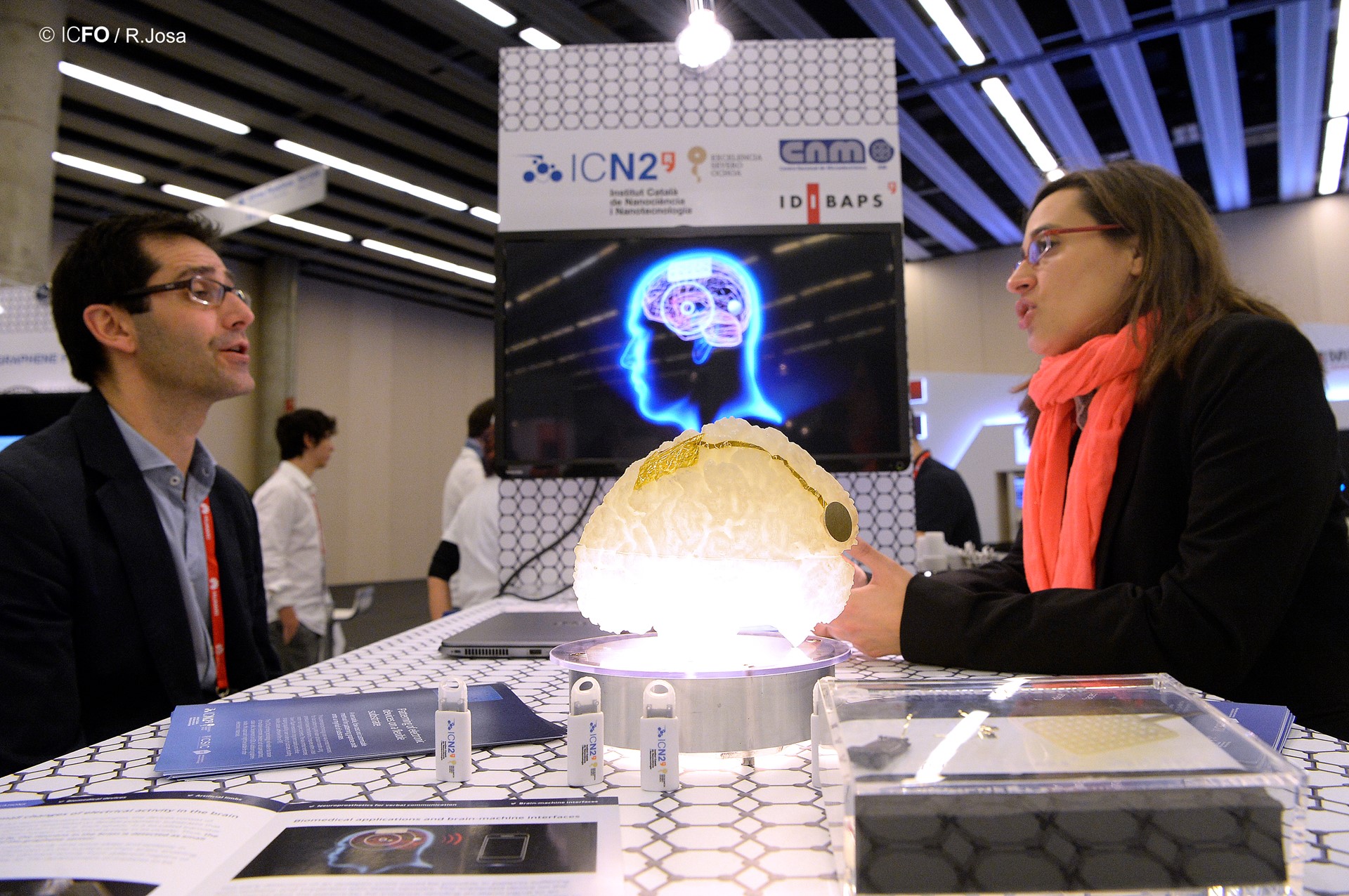 Researchers with a model brain, preparing to introduce their prototype-