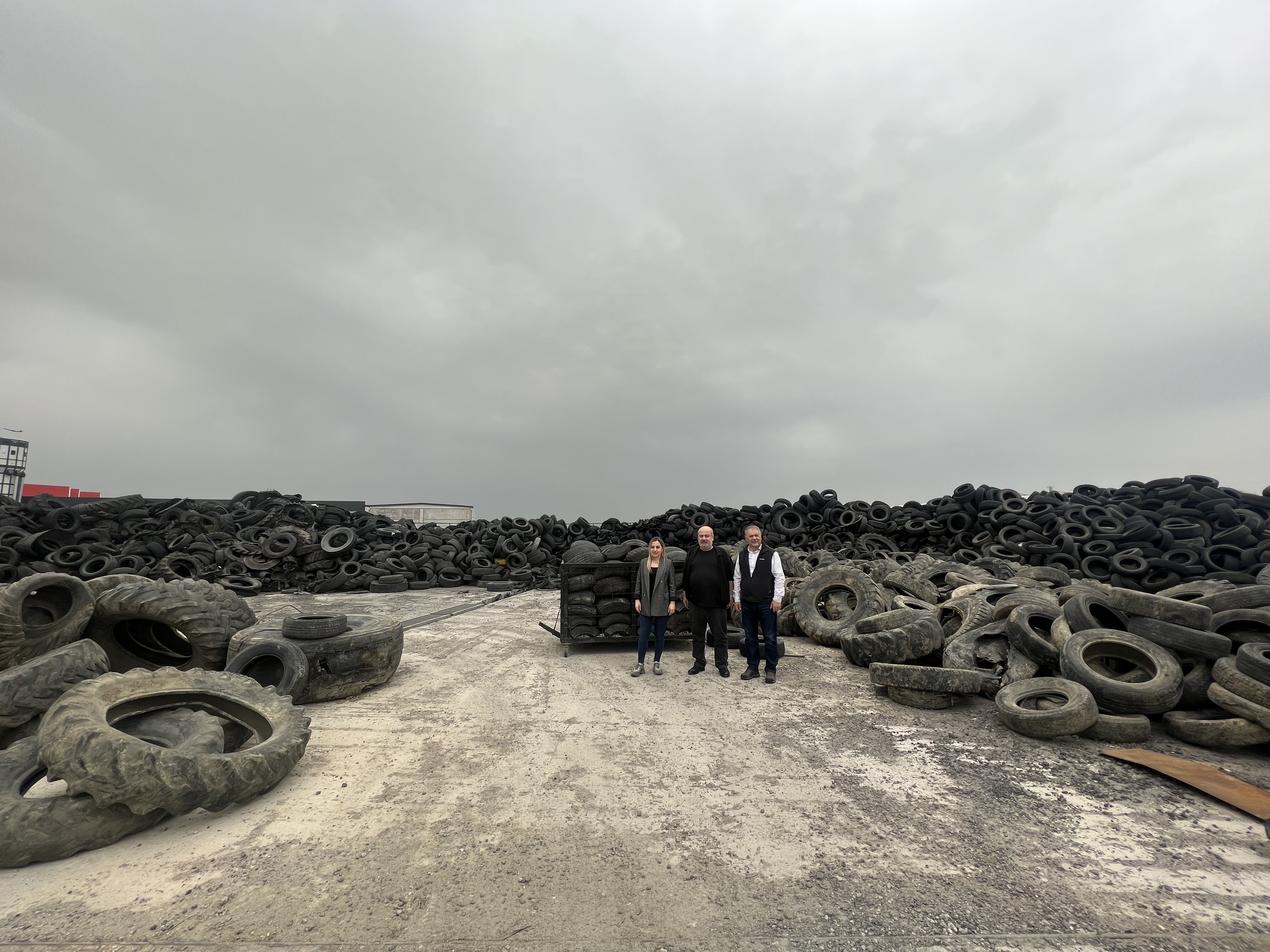 Members of the Nanografen team at a waste tyre disposal site.