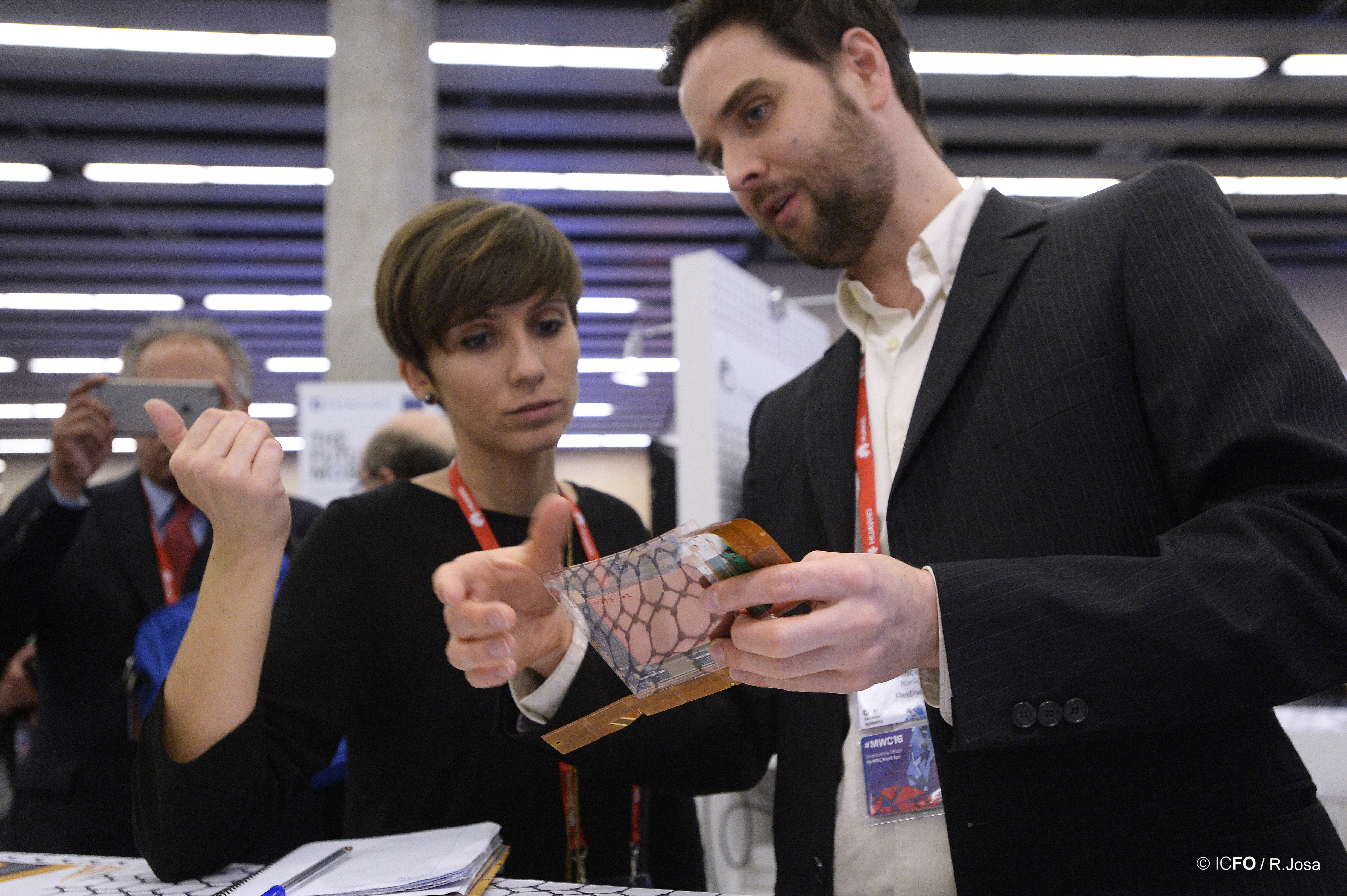 Researcher explaining his prototype at the Graphene Pavilion