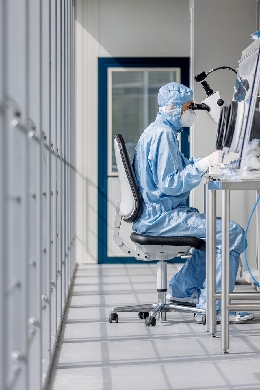 A scientist working on a chip housing in the AMO cleanroom. 