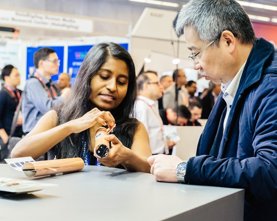 Researcher explaining a prototype at the Graphene Pavilion at Mobile World Congress 2018